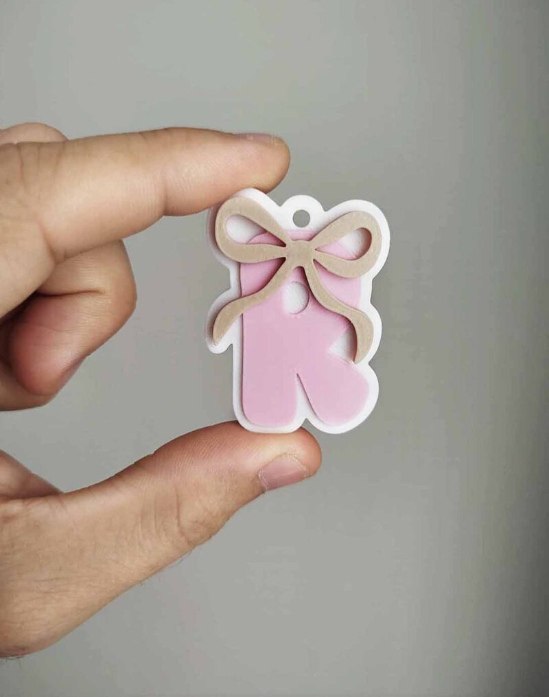 initial keyring with bow